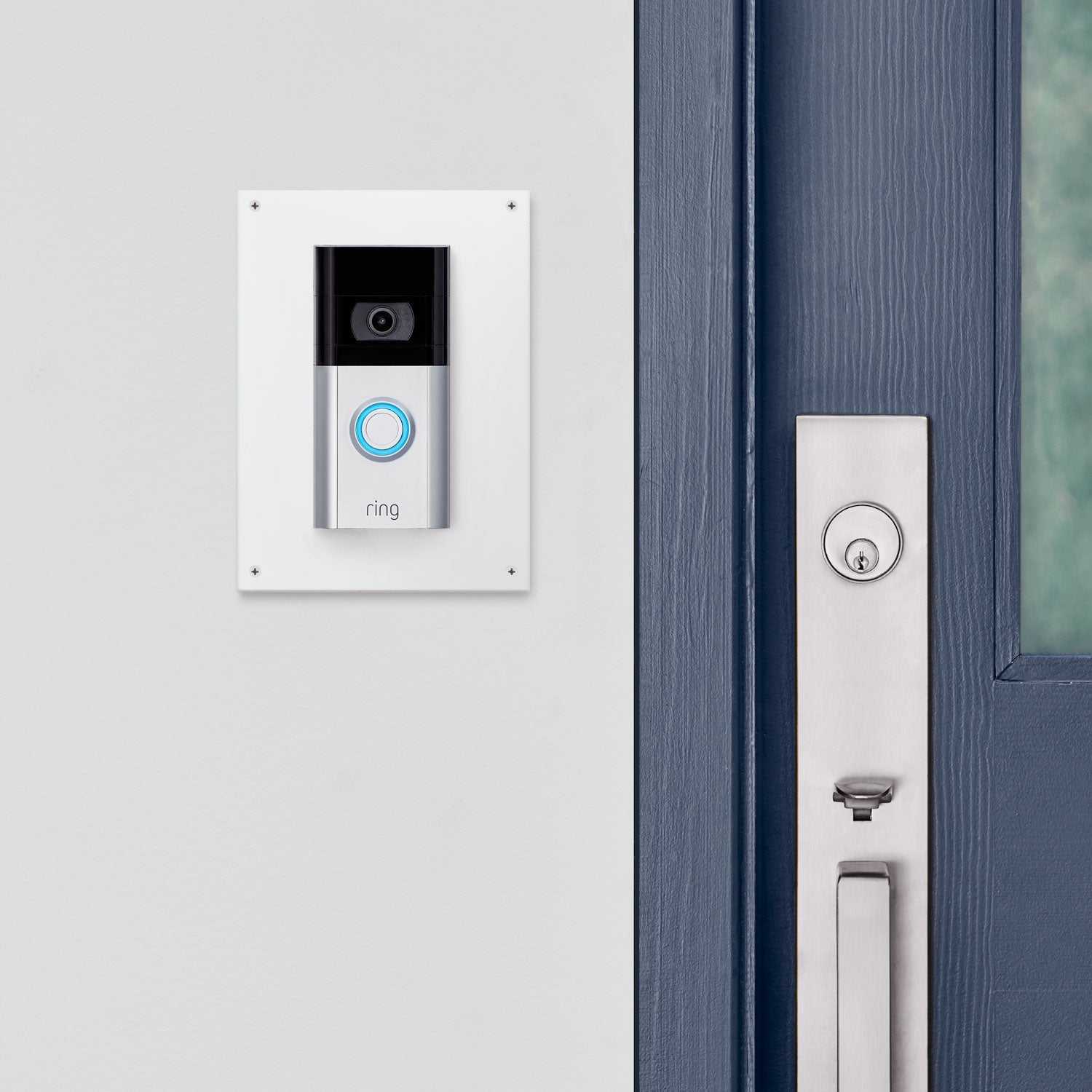 Ring Intercom Kit - Ring Video Doorbell mounted on a white wall using an Intercom Kit next to a blue door.