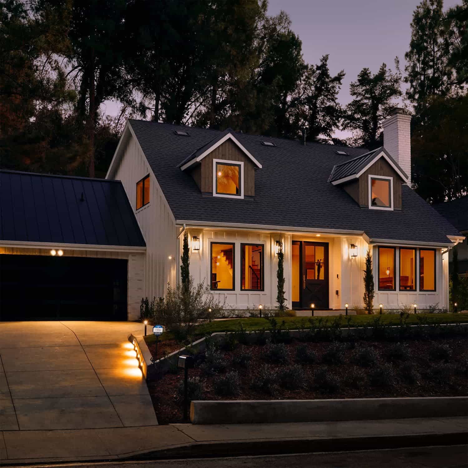 Smart Lighting Pathlight Battery - Modern home at dusk with Ring Smart Lighting Pathlights illuminating the driveway, path, and entry.