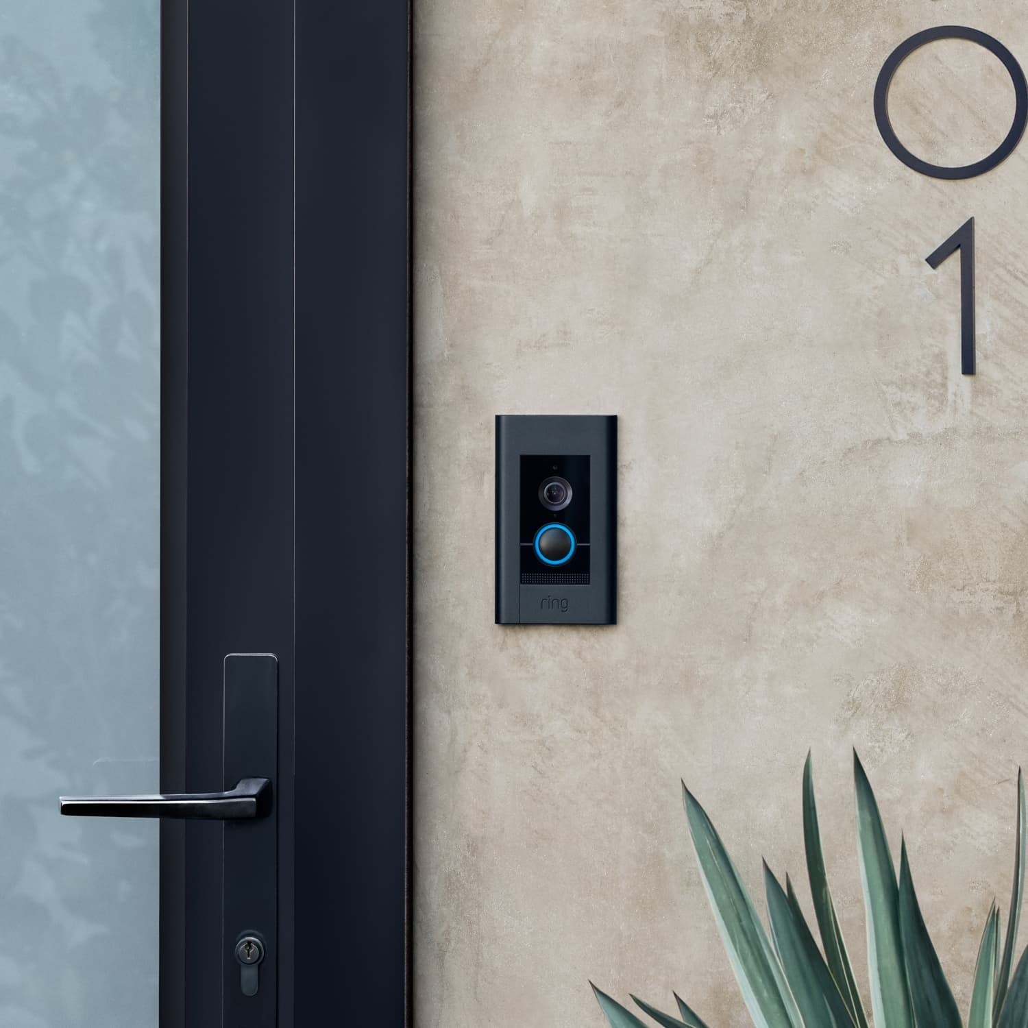 Video Doorbell Elite (Power over Ethernet) - A Ring Video Doorbell Elite with satin black faceplate and blue-lit button, flush-mounted on a tan wall.