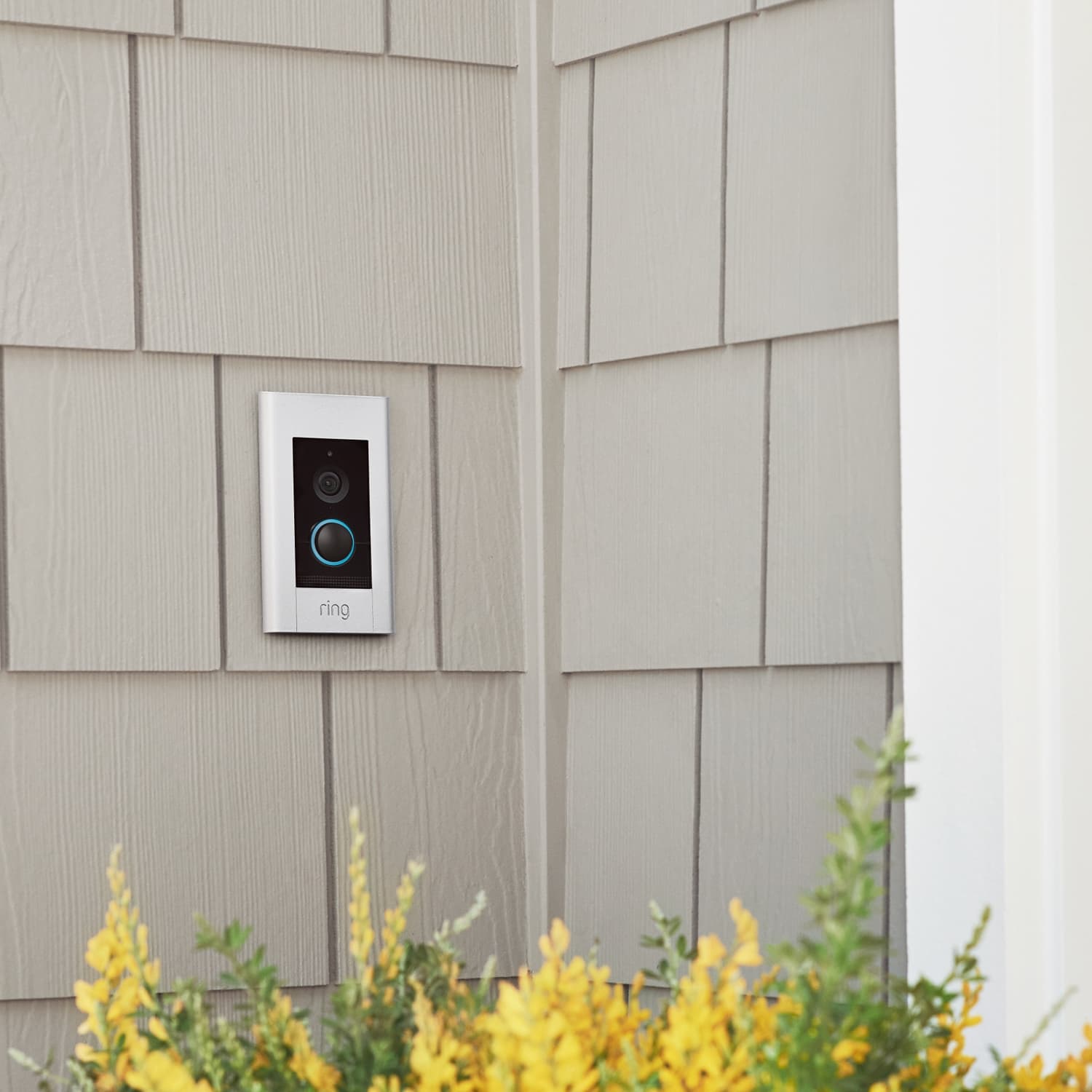 Video Doorbell Elite (Power over Ethernet) - Ring Video Doorbell Elite with pearl white faceplate flush-mounted on grey shingle siding of a home.