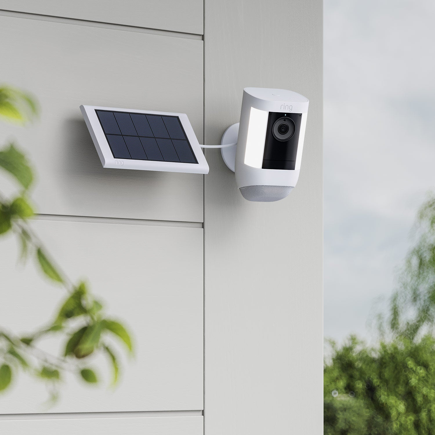 Small Solar Panel (USB-C) (for Outdoor Cam (Stick Up Cam), Outdoor Cam Plus, Stick Up Cam Pro, Spotlight Cam Plus, Spotlight Cam Pro) - White Ring Spotlight Cam and Small Solar Panel on wall, connected by cable for continuous solar-powered camera charging.
