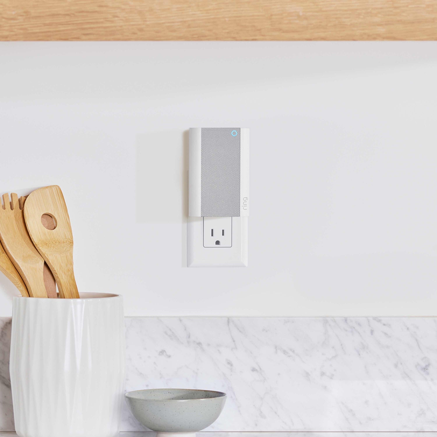 Chime Pro (Certified Refurbished) - Ring Chime Pro plugged into kitchen outlet near a grey bowl and a white ceramic utensil holder.