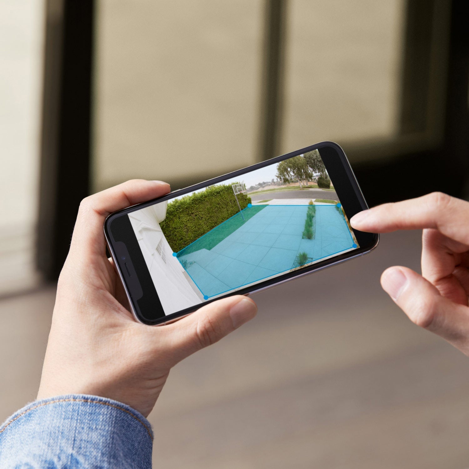 Spotlight Cam Plus - Battery:Ring App showing with customizable motion detection zone outlined in blue over driveway and walkway in daylight.