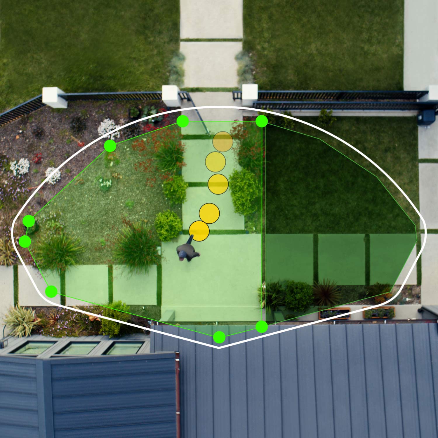 Wired Doorbell Pro - Aerial view of front of house showing bird's eye view zones in green. Person walks toward front door, their path indicated by yellow dots.