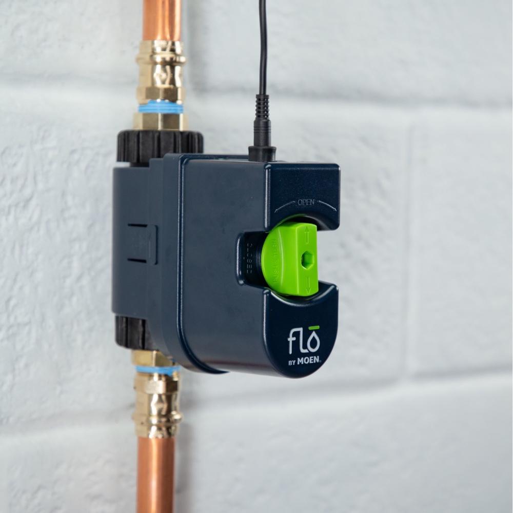 Flo by Moen 3/4-Inch Smart Water Shutoff (for Works with Ring) - Flo by Moen three-quarter-inch Smart Water Shutoff valve on copper pipe, with green control knob and wired connection.