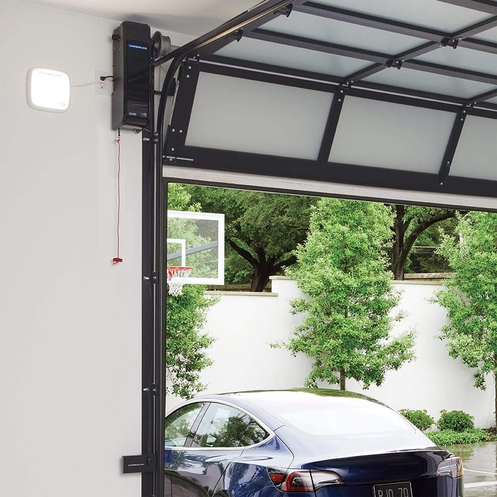 Chamberlain® Next-Gen Wi-Fi® Garage Door Opener (for Works with Ring) - Chamberlain Next-Gen Wi-Fi Garage Door Opener installed next to open garage door, with car exiting.