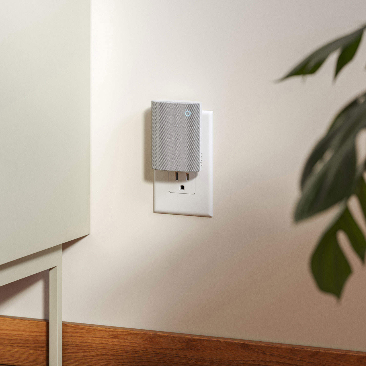 Chime (3rd Gen) - Ring's Chime (3rd Gen) plugged into the living room wall. Credenza and indoor plant shown.