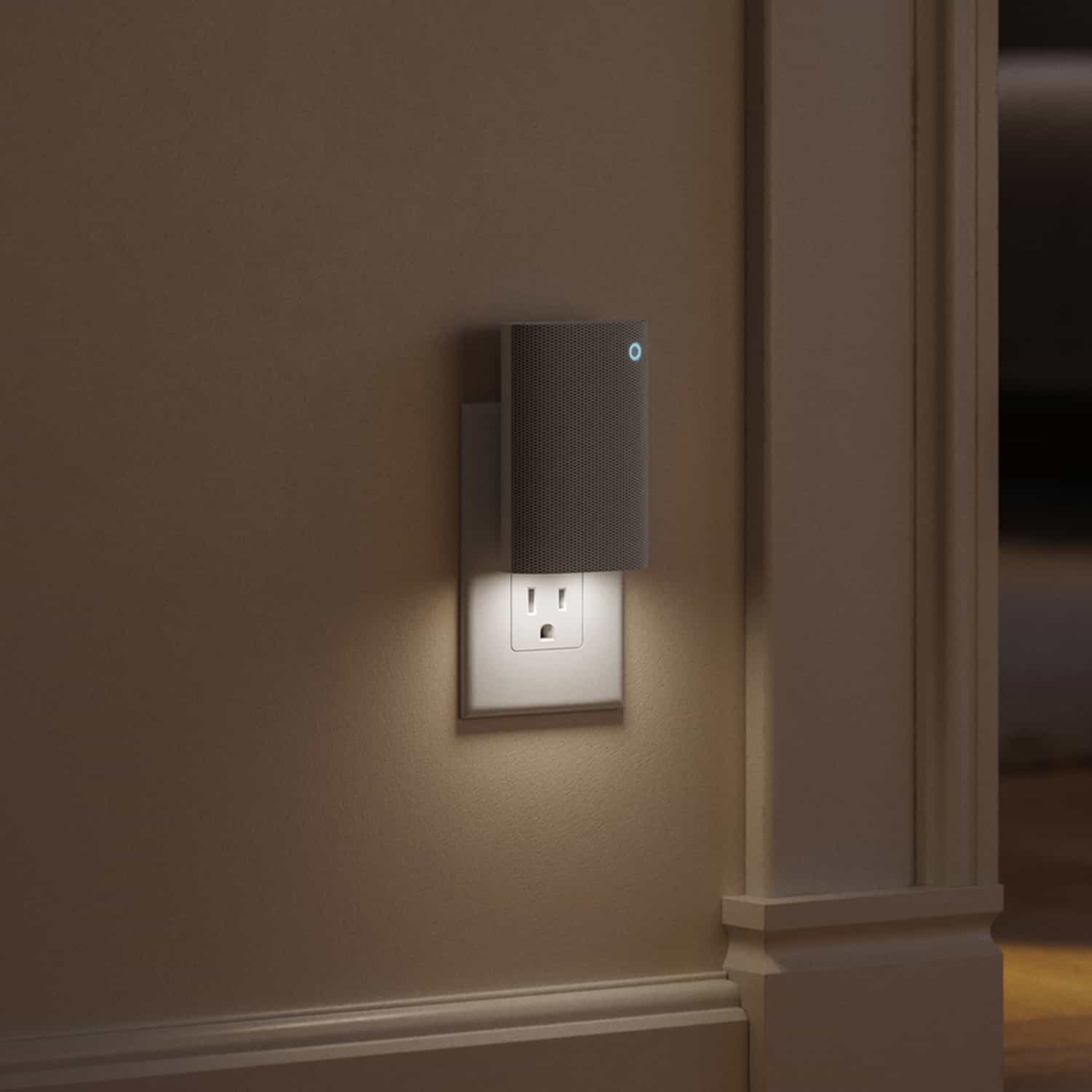 Chime Plus - Plug-in wall device with a small blue indicator light and built-in nightlight illuminating an electrical outlet in a dim hallway.