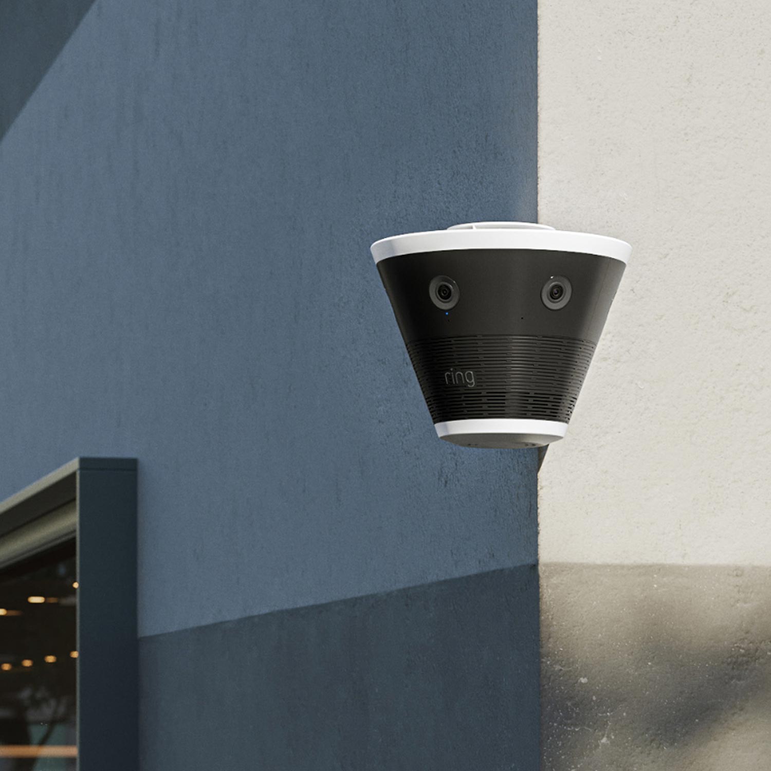 Ring Elite 270 4K - Black and white cone-shaped Ring outdoor camera with dual lenses mounted on a corner wall of a modern building.