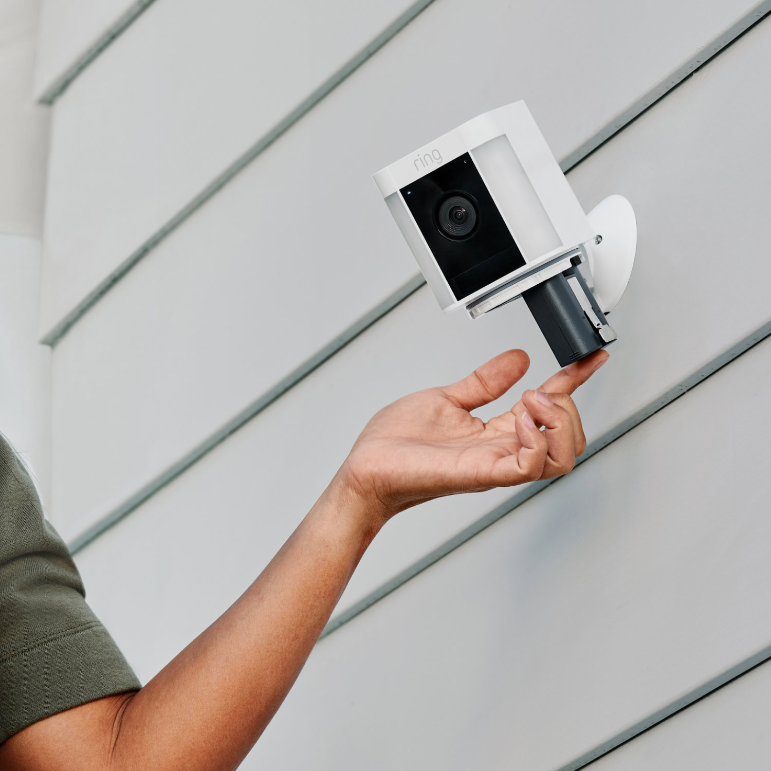 Battery Doorbell Pro + Spotlight Cam Plus Battery - Family using Ring App on smartphone to view home, communicate with visitors, and control connected Ring devices.