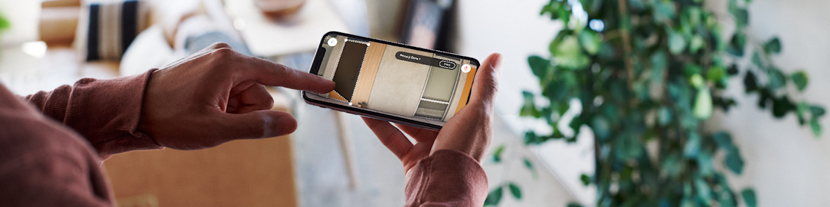 Hands holding a smartphone displaying video footage 