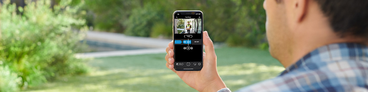 Person using smartphone app outdoors with blurred nature background